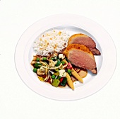 Honey lacquered duck breast with cantonese vegetables on plate