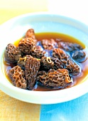 Close-up of cooked black morels in bowl