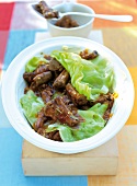 Oxtail with cabbage leaves in serving dish