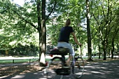 Rear view of woman cycling in park