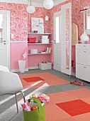 Pink floral pattern wallpaper and colourful carpet with squares in corridor