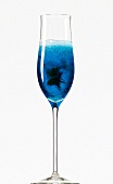 Close-up of 'Blue Lagoon' with curacao, cherry brandy and champagne in champagne flute