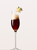 Guinness beer and champagne in glass with star fruit on white background