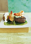 Beef and shrimp with herbs, butter, sour cream and potato in serving dish