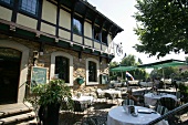 Tables laid outdoors of restaurant, Germany