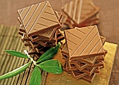 Stacks of olive chocolates with olive leaves