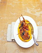 Roasted quail with polenta on serving dish