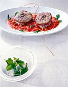 Beef medallions with pizzaiola sauce on serving dish
