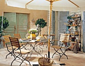 Garden terrace with deck chairs and iron table