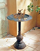 Nostalgic bird bath made of cast iron in garden terrace