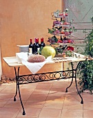 Country style table laid with drinks and fruits on garden terrace