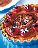 Close-up of chocolate tart with cardamom plum