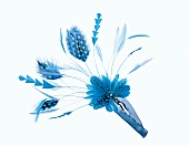 Close-up of hair ornament and blue feathers on spring clip