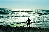 View of sea and surfer at beach in Sanary-sur-Mer, France