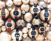 Close-up of ten different watches placed on metal balls