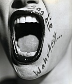 Close-up of woman's mouth opened wide with text on side 'Tell the truth', Black and White 