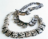 Close-up of black and white pattern necklace made of animal bones in ethnic look