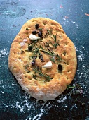 Close-up of Italian flatbread with olive salt and herbs