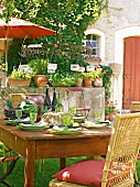 Dining table laid with dishes and glasses in garden of La Dolce Vita, Riomaggiore, Italy