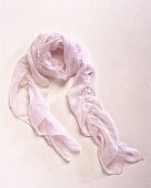 Close-up of delicate pink scarf on pink background