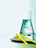 Chemical dissolving in a conical flask on tray
