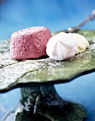 Two meringues with frozen berries yogurt on serving dish