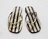 Pair of striped sandals on white background