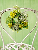 Iron chair decorated with a mini wreath of meadow chervil and euphorbia