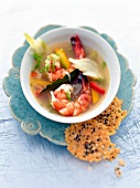 Fennel soup with peppers, king prawns and parmesan in bowl
