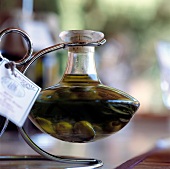 Close-up of olive oil bottle on silver holder