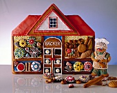 Gingerbread in shape of house decorated with cookies, studio shot