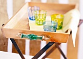 Four glasses kept on wooden tray