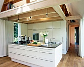 Living and dining area with kitchen and built-in wardrobe in white