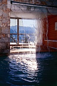 Swimming pools and artificial waterfall inside house