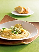 Spaghetti with olive and almond pesto on plate