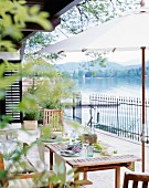 A table laid on a terrace overlooking the Wörthersee