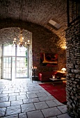Entrance hall with chandeliers, arches of stone and white tiled floor