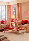 Living room with bright furniture and red cushion on sofa