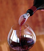 Close-up of decanted red wine being poured in wine glass