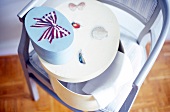 Stack of blue and white storage boxes on chair