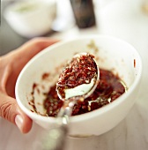 Close-up of spicy dip with spoon in bowl