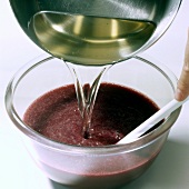 Close-up of syrup being poured in fruit puree