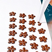 Chocolate flowers being made with piping bag