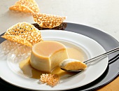 Creme caramel with almond crisps on plate