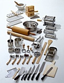 Different types of equipment for pasta dishes on white background