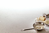 Veloute and ingredients with pan and whisk on white background, copy space