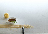 Cup of clear soup, pasta and capelli d'angelo on white background, copy space
