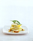 Stacked of sliced apple with yogurt and horseradish dressing on plate