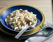 Pasta with fish on plate with fork