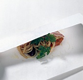 Covering noodles with herbs with parchment paper, step 3